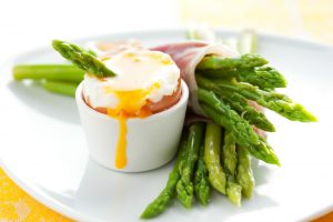 Boiled eggs with ham-wrapped asparagus soldiers